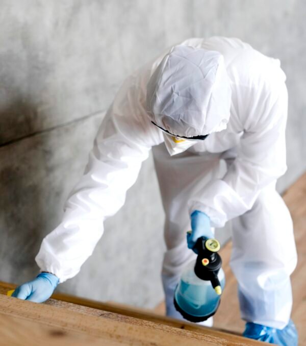 full-shot-man-with-suit-disinfecting-stairs