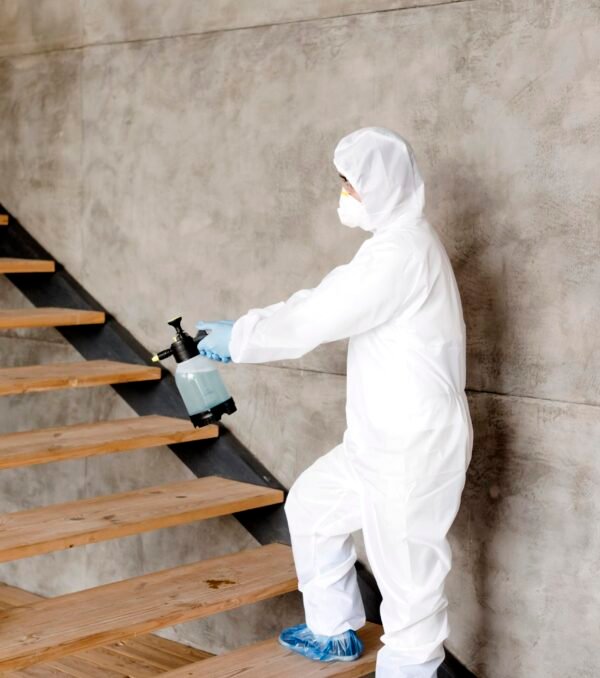side-view-man-disinfecting-stairs